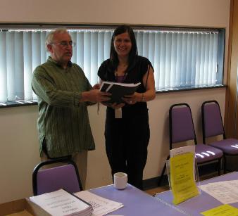 Jim Rayner presenting copies of his book to Hannah Quinlan